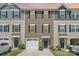 View of townhome exteriors with garages, well-kept lawns and dark shutters at 706 Dillon Way, Fort Mill, SC 29715