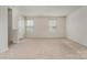 Living room with carpet flooring, two windows for natural light, and neutral paint at 706 Dillon Way, Fort Mill, SC 29715