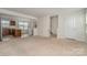 Open-concept layout with a view of the stairs and kitchen with tile flooring and ample natural light at 706 Dillon Way, Fort Mill, SC 29715