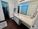 Well-lit bathroom featuring a large mirror, vanity, and accessible walk-in closet at 712 Harrier Rd, Charlotte, NC 28216
