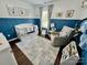 Cozy Bedroom with a white crib, blue wainscoting, glider, and natural light at 712 Harrier Rd, Charlotte, NC 28216