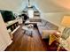Well-lit bonus room with sectional, desk, tv, and glass coffee tables at 712 Harrier Rd, Charlotte, NC 28216