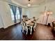 Inviting dining room featuring modern decor, a stylish chandelier, and hardwood flooring at 712 Harrier Rd, Charlotte, NC 28216
