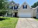 Charming two-story home with a two-car garage, well-maintained lawn, and classic architectural details at 712 Harrier Rd, Charlotte, NC 28216