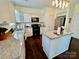 Bright kitchen featuring granite counters, stainless steel appliances, and a functional center island at 712 Harrier Rd, Charlotte, NC 28216