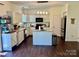 Modern kitchen with granite countertops, stainless steel appliances, and a center island at 712 Harrier Rd, Charlotte, NC 28216