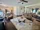 Open-concept living room connects to kitchen and dining, featuring hardwood floors and ample natural light at 712 Harrier Rd, Charlotte, NC 28216