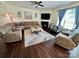 Spacious living room with comfortable seating, a fireplace, and a ceiling fan at 712 Harrier Rd, Charlotte, NC 28216
