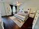 Serene main bedroom featuring a ceiling fan, large windows, and contemporary decor at 712 Harrier Rd, Charlotte, NC 28216