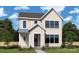 Charming two-story home with a classic farmhouse design, large windows, and a welcoming front porch at 7213 Westrow Ave, Charlotte, NC 28278