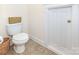 Toilet in a bathroom with a tan tile floor at 7344 Gilead Rd, Huntersville, NC 28078