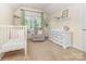 Charming Bedroom with a crib, dresser, and comfortable chair, perfect for a growing Gathering at 7344 Gilead Rd, Huntersville, NC 28078