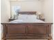 Serene bedroom featuring a dark wood bed frame and soft, natural lighting at 7344 Gilead Rd, Huntersville, NC 28078
