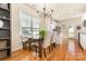 Bright dining area with a wooden table, bench, and chairs, adjacent to a modern kitchen at 7344 Gilead Rd, Huntersville, NC 28078