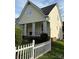 Charming home with a welcoming porch and a neat white picket fence, surrounded by lush greenery at 7344 Gilead Rd, Huntersville, NC 28078