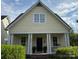 Inviting home featuring a classic design, large windows, and a well-maintained front garden at 7344 Gilead Rd, Huntersville, NC 28078