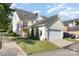 Exterior shot showing the home, garage, lush landscaping, and driveway parking at 7344 Gilead Rd, Huntersville, NC 28078