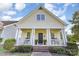 Charming home with a welcoming porch, showcasing classic architectural details and landscaping at 7344 Gilead Rd, Huntersville, NC 28078