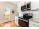 Modern kitchen featuring stainless steel appliances, white cabinets, and granite countertops at 7344 Gilead Rd, Huntersville, NC 28078