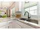 Close-up of a kitchen sink and counter, highlighting the granite countertops and stainless steel fixtures at 7344 Gilead Rd, Huntersville, NC 28078
