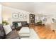 Inviting living space with hardwood floors, a comfortable sofa, and open access to the dining area at 7344 Gilead Rd, Huntersville, NC 28078