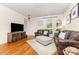 Cozy living room featuring hardwood floors, ample seating, and natural light at 7344 Gilead Rd, Huntersville, NC 28078