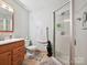 Bathroom showcasing a glass enclosed shower, and wood-trimmed vanity sink at 7639 Winterset Dr, Charlotte, NC 28270
