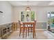 Charming dining area featuring a hanging plant, natural light, and a rattan pendant lamp at 7639 Winterset Dr, Charlotte, NC 28270
