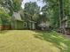 View of the home's exterior, showcasing a well-maintained yard, a spacious deck, and a back entrance at 7639 Winterset Dr, Charlotte, NC 28270