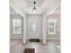 Inviting foyer with wood-look flooring, white trim, and a classic pendant light, offering a glimpse into adjacent rooms at 7639 Winterset Dr, Charlotte, NC 28270