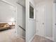 Bright hallway showcasing carpet and multiple doors leading to different rooms at 7639 Winterset Dr, Charlotte, NC 28270