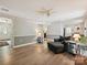 Open-concept living room with wood flooring, a comfortable chaise lounge, and access to multiple areas of the home at 7639 Winterset Dr, Charlotte, NC 28270