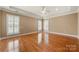 Large bedroom showcasing hardwood floors, tray ceiling and multiple windows with plantation shutters at 765 Cherry Hills Pl, Rock Hill, SC 29730