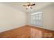 Bright bedroom with hardwood floors, ceiling fan, and large window with white shutters at 765 Cherry Hills Pl, Rock Hill, SC 29730