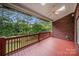 Relax on this covered deck with a ceiling fan and wooded backyard views at 765 Cherry Hills Pl, Rock Hill, SC 29730
