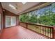 Covered deck with a wood railing, brick supports, and views of the landscaped yard at 765 Cherry Hills Pl, Rock Hill, SC 29730