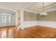 Elegant dining room featuring wainscoting, hardwood floors, and chandelier lighting with a tray ceiling at 765 Cherry Hills Pl, Rock Hill, SC 29730