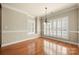 Elegant dining room with hardwood floors, decorative molding, and plantation shutters at 765 Cherry Hills Pl, Rock Hill, SC 29730