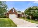 Charming brick home with a well-manicured lawn and attached two-car garage at 765 Cherry Hills Pl, Rock Hill, SC 29730