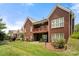 Large brick home with lush backyard, second story deck, and outdoor patio at 765 Cherry Hills Pl, Rock Hill, SC 29730