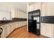 Bright kitchen with granite countertops, custom cabinetry, a modern refrigerator and beautiful hardwood floors at 765 Cherry Hills Pl, Rock Hill, SC 29730