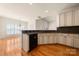 Spacious kitchen with stainless steel dishwasher, hardwood floors, granite countertops, and custom cabinetry at 765 Cherry Hills Pl, Rock Hill, SC 29730