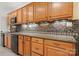Close-up of the oak cabinets and mosaic backsplash in the basement kitchenette at 765 Cherry Hills Pl, Rock Hill, SC 29730
