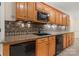 Basement kitchenette featuring wood cabinets and mosaic tile backsplash at 765 Cherry Hills Pl, Rock Hill, SC 29730