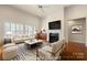 Bright living room boasts large windows with shutters, fireplace, and cozy seating area at 765 Cherry Hills Pl, Rock Hill, SC 29730