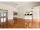 Bright open-concept living room with hardwood floors, stylish lighting, and seamless access to kitchen at 765 Cherry Hills Pl, Rock Hill, SC 29730