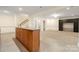 Open living space with kitchenette bar and adjacent carpeted den offers versatility and comfort at 765 Cherry Hills Pl, Rock Hill, SC 29730