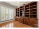 Home office showcasing custom built-in shelving with wood floors and large window views at 765 Cherry Hills Pl, Rock Hill, SC 29730