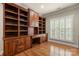 Home office featuring custom built-in bookshelves, wood floors, and ample natural light at 765 Cherry Hills Pl, Rock Hill, SC 29730