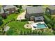 Aerial view of landscaped backyard featuring a pool, fire pit, and basketball court at 7903 Tottenham Ct, Waxhaw, NC 28173